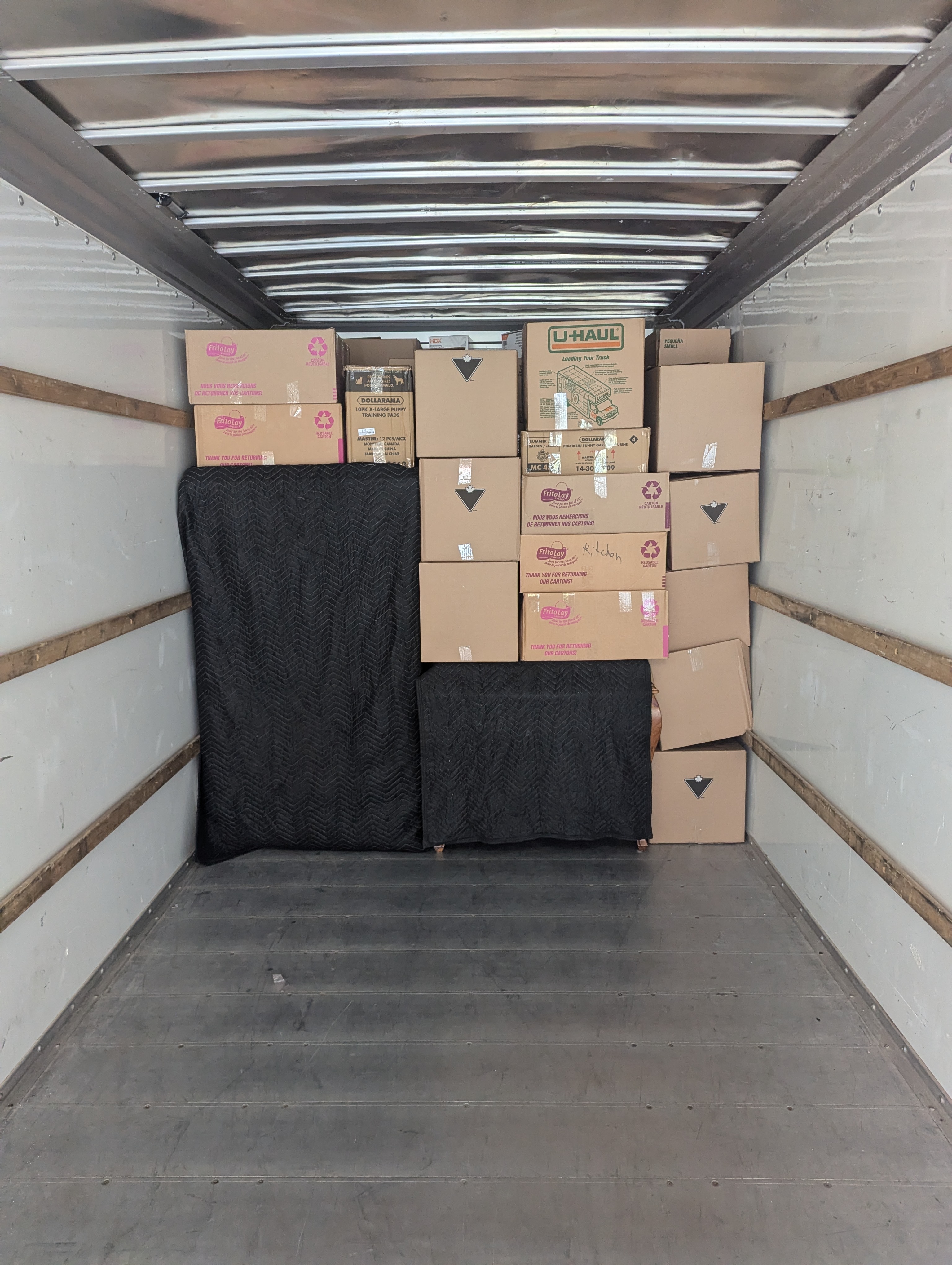A.M Moving crew loading household furniture into a moving truck in Greater Sudbury.